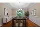Elegant dining room with modern chandelier, hardwood floors, and natural light at 1153 Litchborough Way, Wake Forest, NC 27587