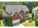 Exterior elevation of a brick two-story home with an attached garage and manicured landscaping at 1153 Litchborough Way, Wake Forest, NC 27587