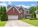 Picture of a brick two-story home with a two-car garage and green lawn at 1153 Litchborough Way, Wake Forest, NC 27587