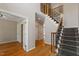 Open foyer with hardwood floors, decorative staircase, and neutral paint at 1153 Litchborough Way, Wake Forest, NC 27587