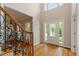 Bright foyer featuring hardwood floors, a staircase, and a decorative front door at 1153 Litchborough Way, Wake Forest, NC 27587