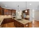 Gourmet kitchen with island cooktop, stainless steel appliances, and granite counters at 1153 Litchborough Way, Wake Forest, NC 27587