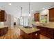 Bright open kitchen featuring a gas stovetop, granite countertops and hardwood floors at 1153 Litchborough Way, Wake Forest, NC 27587