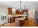 Spacious kitchen with granite countertops, stainless steel appliances, and hardwood floors at 1153 Litchborough Way, Wake Forest, NC 27587