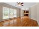 Sun-filled living room with hardwood floors and view of the kitchen at 1153 Litchborough Way, Wake Forest, NC 27587
