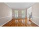 Picture of a sunny and open living room featuring hardwood floors and white trim at 1153 Litchborough Way, Wake Forest, NC 27587