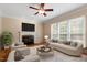 Comfortable living room with fireplace, hardwood floors, and lots of natural light at 1153 Litchborough Way, Wake Forest, NC 27587