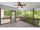 Enclosed patio with wood flooring, ceiling fan, and views to the outside at 1153 Litchborough Way, Wake Forest, NC 27587