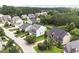 Street view of homes with well-maintained lawns and mature trees in a quiet, suburban neighborhood at 1153 Litchborough Way, Wake Forest, NC 27587