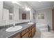 Bathroom featuring a double sink vanity and soaking tub at 116 Justice St, Chapel Hill, NC 27516