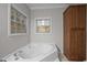 Bright bathroom features a large soaking tub and wooden cabinetry at 116 Justice St, Chapel Hill, NC 27516