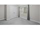Bedroom with light grey carpet and walls, a window and a closet at 116 Justice St, Chapel Hill, NC 27516