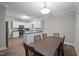 Dining area blends into a bright kitchen, boasting ample counter space and white cabinets at 116 Justice St, Chapel Hill, NC 27516