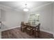 Dining area boasts wood-look floors, neutral paint and large window offering natural light at 116 Justice St, Chapel Hill, NC 27516