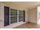 Front porch with a welcome mat, a storm door, and a large window at 116 Justice St, Chapel Hill, NC 27516