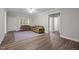 Bright living room features wood-look flooring, neutral paint, ceiling fan and several entryways at 116 Justice St, Chapel Hill, NC 27516