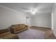 Cozy living room featuring neutral paint, ceiling fan, and wood-look flooring throughout at 116 Justice St, Chapel Hill, NC 27516