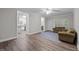 Spacious living room features wood-look flooring, neutral paint, ceiling fan and several entryways at 116 Justice St, Chapel Hill, NC 27516