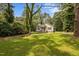 Nestled amongst mature trees, this home has a beautiful lawn and front yard at 116 Justice St, Chapel Hill, NC 27516