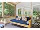 Relaxing back porch with a hanging swing bed, providing a comfortable outdoor space with views of the yard at 11619 Appaloosa W Run, Raleigh, NC 27613