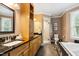 Bathroom with a vanity, a shower with glass door, toilet, and a soaking tub at 11619 Appaloosa W Run, Raleigh, NC 27613
