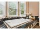 Elegant bathtub with black and white tile surround, set against a backdrop of bright windows at 11619 Appaloosa W Run, Raleigh, NC 27613