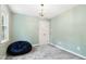 The bedroom features neutral tones with a lovely chandelier at 11619 Appaloosa W Run, Raleigh, NC 27613