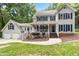 Traditional two-story home featuring neutral siding, dark shutters, covered porch, and mature landscaping at 11619 Appaloosa W Run, Raleigh, NC 27613