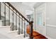 Welcoming foyer with hardwood floors, staircase, and a beautiful front door with leaded glass at 11619 Appaloosa W Run, Raleigh, NC 27613
