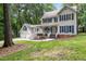 Inviting two-story home boasts a charming porch, mature trees, and a two-car garage at 11619 Appaloosa W Run, Raleigh, NC 27613