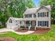 Inviting two-story home boasts a charming porch, mature trees, and a two-car garage at 11619 Appaloosa W Run, Raleigh, NC 27613