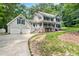 Inviting two-story home boasts a charming porch, mature trees, and a two-car garage at 11619 Appaloosa W Run, Raleigh, NC 27613