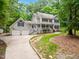 Inviting two-story home boasts a charming porch, mature trees, and a two-car garage at 11619 Appaloosa W Run, Raleigh, NC 27613