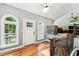 Hallway featuring hardwood floors, white trim, arched windows, and view of the living room at 11619 Appaloosa W Run, Raleigh, NC 27613
