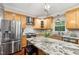 Kitchen featuring stainless steel appliances, hardwood floors, a granite island and ample counterspace at 11619 Appaloosa W Run, Raleigh, NC 27613