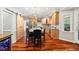 Well-lit kitchen with a large island, barstool seating, hardwood floors, and stainless steel appliances at 11619 Appaloosa W Run, Raleigh, NC 27613