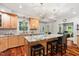 Spacious kitchen featuring hardwood floors, stainless steel appliances, and a large island with seating at 11619 Appaloosa W Run, Raleigh, NC 27613