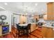 Kitchen with hardwood floors, stainless steel appliances, granite countertops, and beverage fridge at 11619 Appaloosa W Run, Raleigh, NC 27613