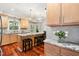 Bright kitchen with hardwood floors, an island with barstool seating, and a sliding barn door at 11619 Appaloosa W Run, Raleigh, NC 27613