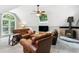 Cozy living room with leather furniture, a ceiling fan, skylight, and a brick fireplace at 11619 Appaloosa W Run, Raleigh, NC 27613