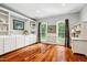 Bright office with built-in shelving and cabinets, hardwood floors, and large windows providing natural light at 11619 Appaloosa W Run, Raleigh, NC 27613