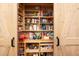 Pantry with barn doors featuring custom pull out shelving for food storage at 11619 Appaloosa W Run, Raleigh, NC 27613
