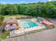 Aerial view of community pool with red and white buildings and ample parking at 11619 Appaloosa W Run, Raleigh, NC 27613