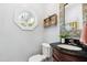 Charming powder room with unique octagonal window, stylish mirror, and vanity with a granite countertop at 11619 Appaloosa W Run, Raleigh, NC 27613
