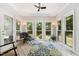 Bright sunroom with lots of windows providing views of the backyard, a ceiling fan, and tile floors at 11619 Appaloosa W Run, Raleigh, NC 27613
