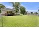 Large backyard showcasing a well-maintained lawn and a charming back porch at 117 S Woodstone Dr, Archer Lodge, NC 27527