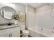 Updated bathroom featuring a granite countertop, modern fixtures, and a bathtub with a shower at 117 S Woodstone Dr, Archer Lodge, NC 27527