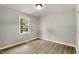 Bright bedroom with hardwood floors, neutral paint, a window and ample natural light at 117 S Woodstone Dr, Archer Lodge, NC 27527