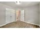 Bright bedroom with hardwood floors, neutral paint, and ample closet space at 117 S Woodstone Dr, Archer Lodge, NC 27527