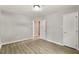 Cozy bedroom featuring hardwood floors, with white trim, and a white door at 117 S Woodstone Dr, Archer Lodge, NC 27527